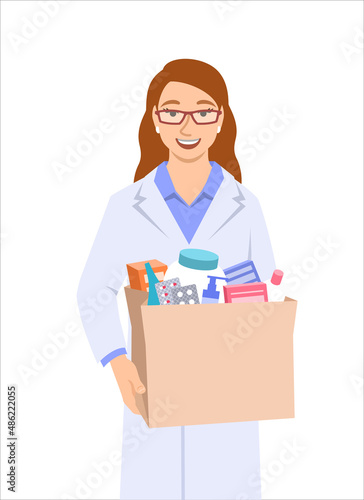 Young woman pharmacist in white coat holding paper bag with medicines and other goods bought in a pharmacy. Female drugstore seller gives the order to the buyer. Drugstore worker isolated on white