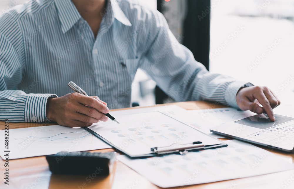 Financial businessman calculating corporate income tax data And analyzing charts of financial stocks that are in good condition with growth and progress, Investment in finance and accounting. Financial businessman calculating corporate income tax data And analyzing charts of financial stocks that are in good condition with growth and progress, Investment in finance and accounting.