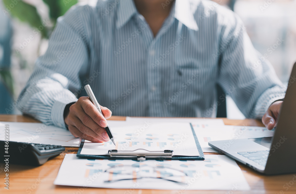 Financial businessman calculating corporate income tax data And analyzing charts of financial stocks that are in good condition with growth and progress, Investment in finance and accounting. Financial businessman calculating corporate income tax data And analyzing charts of financial stocks that are in good condition with growth and progress, Investment in finance and accounting.