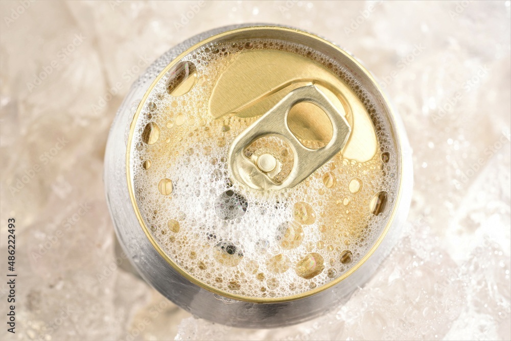 opened beer can in ice top view opened beer can in ice top view