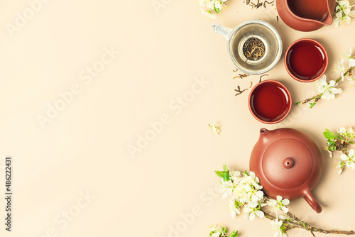 Fotografie Asian Tea set on stone slate board, ceramic teapot, cups, dried tea and spring b