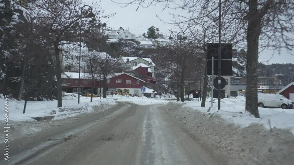 POV From A Car Driving At Winter Towards Buildings In Town. POV From A Car Driving At Winter Towards Buildings In Town.
