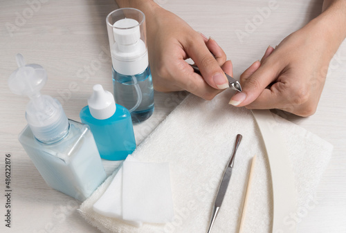A woman does a manicure at home. Manicure tools. Edged manicure. Dangerous manicure. Home care  Spa  beauty. Nail salon 