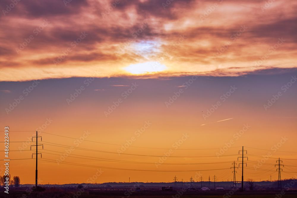 landscape with sunset over a high voltage line