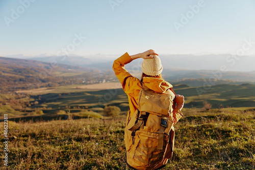 woman traveler backpacking trip to mountains landscape relaxation