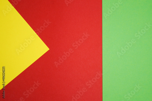 Graphic background of different geometric shapes in 3 colors: green, yellow, red. Copy space. 
