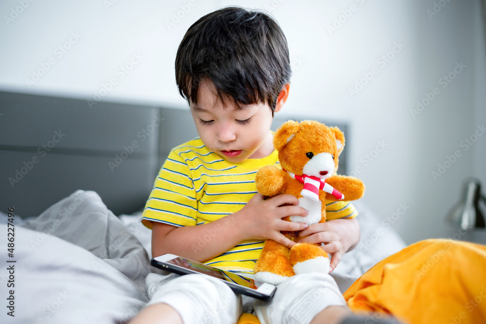 little kid boy using digital tablet or smart phones for playing games and watching cartoons, smart phone mobile addiction technology communication lifestyles. little kid boy using digital tablet or smart phones for playing games and watching cartoons, smart phone mobile addiction technology communication lifestyles.