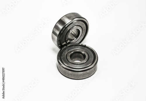 metal ball bearings lie on a white background 