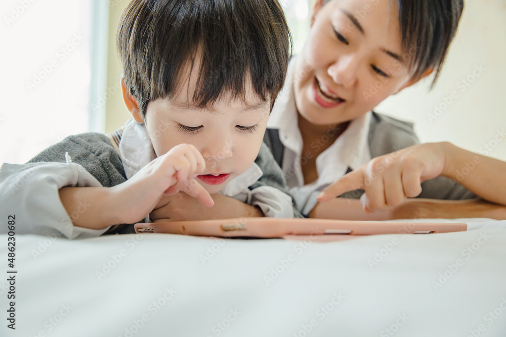 little kids boy cute schoolboy fun and enjoying playing and using digital tablet ,People family learning lifestyle concept.
little kids boy cute schoolboy fun and enjoying playing and using digital tablet ,People family learning lifestyle concept.