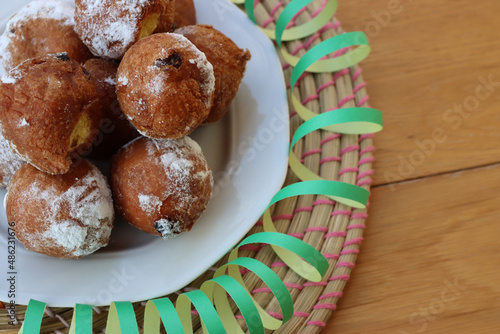 Traditional italian Fritters called Frittelle on a plate with Carnival decorations photo