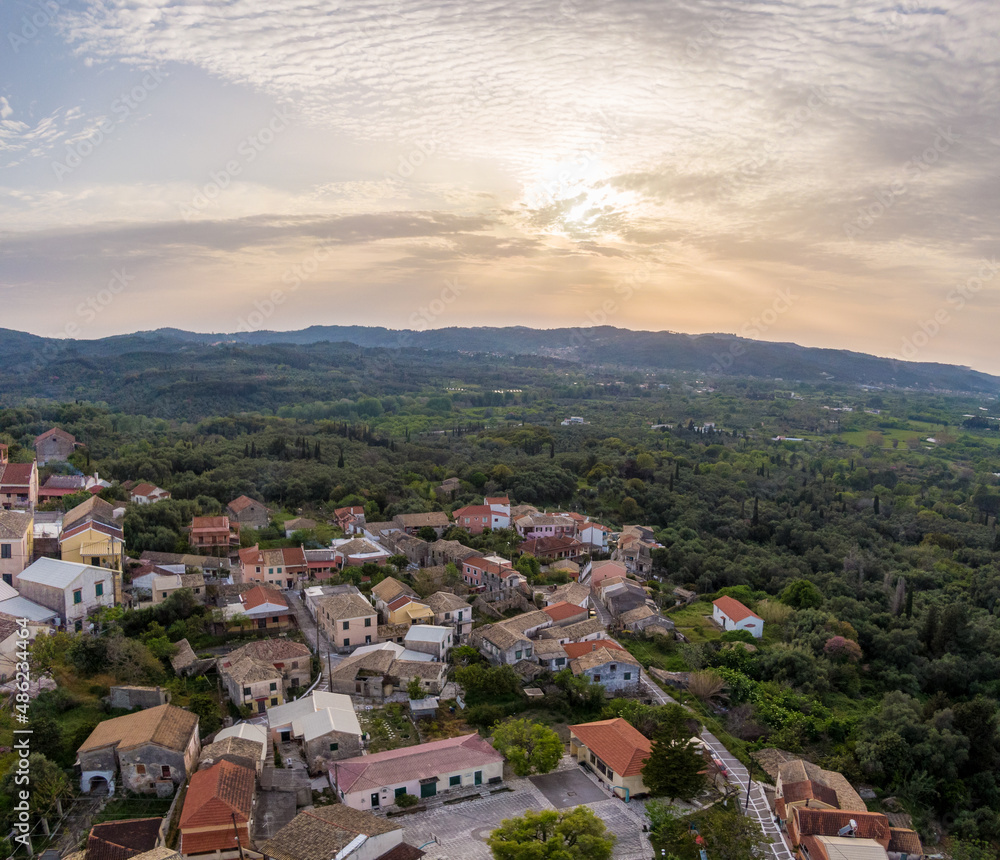 Aerial drone view of beautiful Agioi douloi village in north corfu grece in sunset time