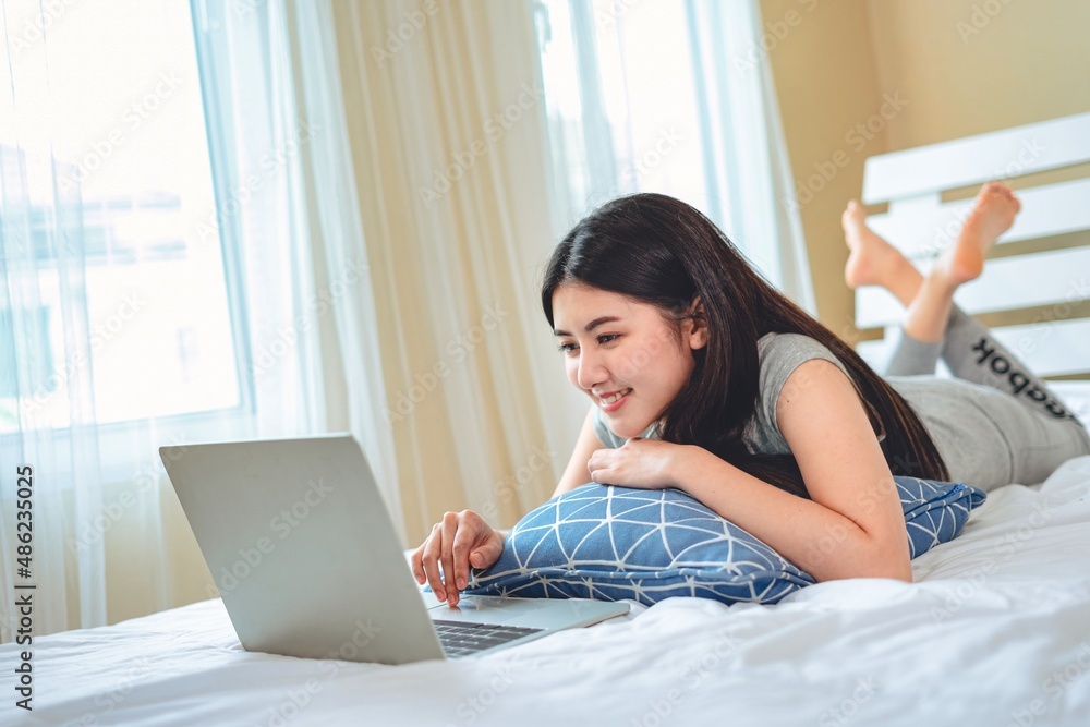 Portrait asian woman using computer laptop in bedroom work from home, Technology communication lifestyles concept. Portrait asian woman using computer laptop in bedroom work from home, Technology communication lifestyles concept.