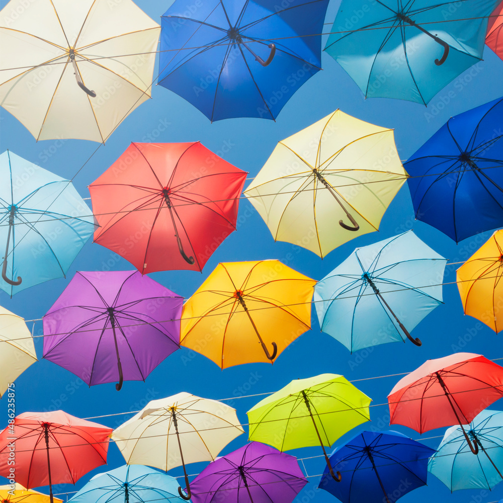 Colorful umbrellas on the sky background, toned.