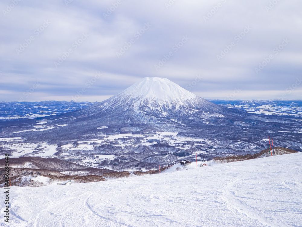 Snowy volcano and town viewed from a ski resort (Niseko, Hokkaido, Japan) Snowy volcano and town viewed from a ski resort (Niseko, Hokkaido, Japan)