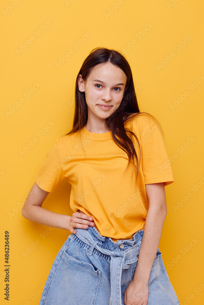 young beautiful woman in a yellow t-shirt emotions summer style isolated background young beautiful woman in a yellow t-shirt emotions summer style isolated background