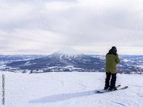 Skier and snowy volcano (Niseko, Hokkaido, Japan)