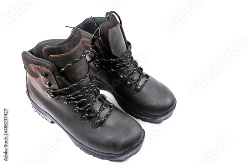 Pair of leather hiking boots on white isolated background. High quality product for outdoor use and adventure.