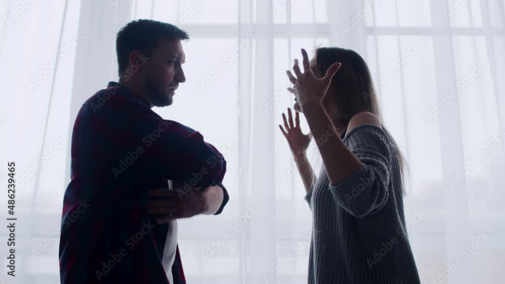 Married couple is swearing in their home, woman is outraged by husband