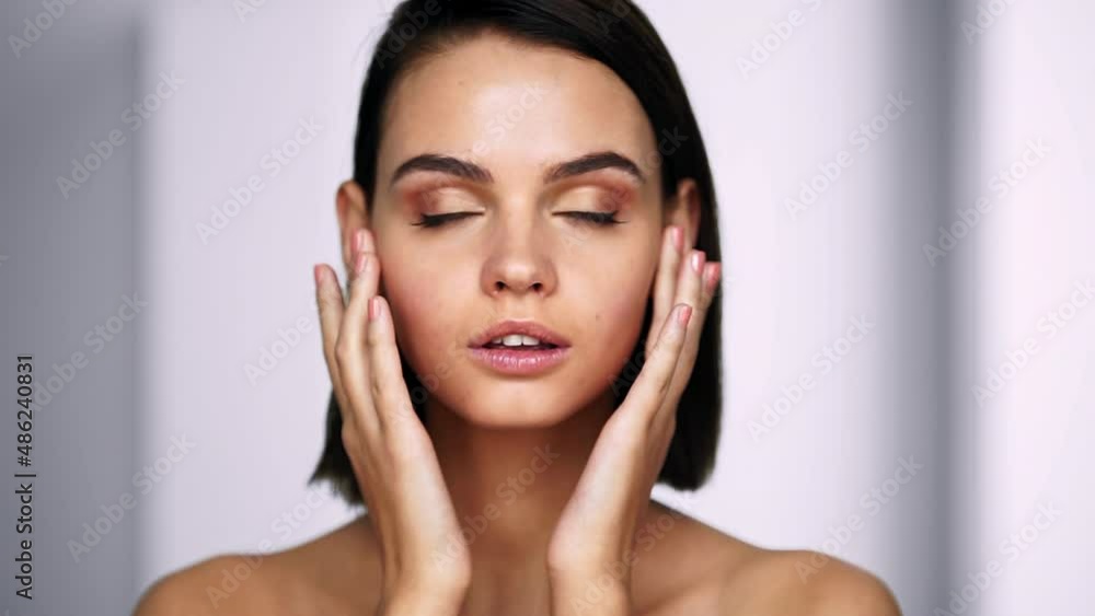 Beautiful woman touching her smooth skin on face. Beauty and Skin care concept. Close up Beautiful woman touching her smooth skin on face. Beauty and Skin care concept. Close up