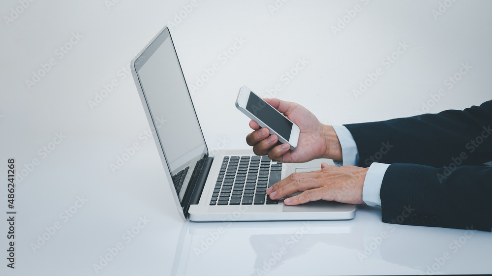 Businessman hand using smartphone with laptop computer. Business and technology concept. Businessman hand using smartphone with laptop computer. Business and technology concept.