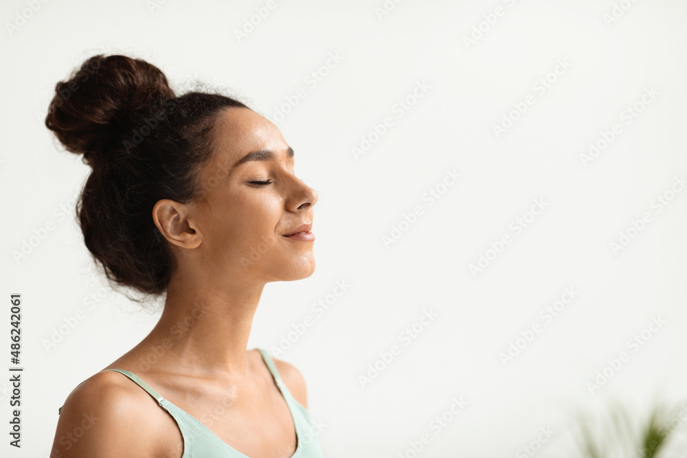Closeup Portrait Of Peaceful Smiling Young Female Standing With Closed Eyes Closeup Portrait Of Peaceful Smiling Young Female Standing With Closed Eyes