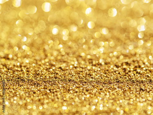 Sparkling golden powder. Festive background. © volff