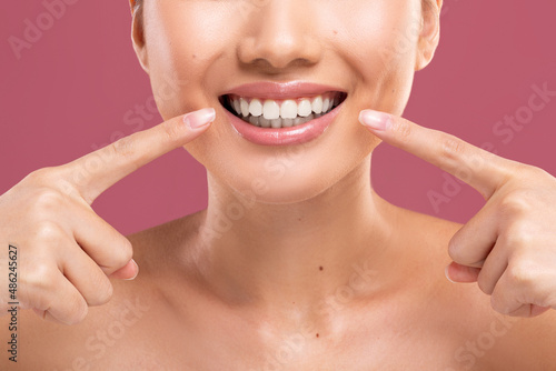 Unrecognizable woman smiling, showing her perfect white teeth