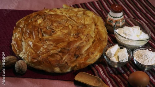Home made cheese pie with phyllo pastry and eggs. Traditional Bulgarian banitsa with white cheese photo