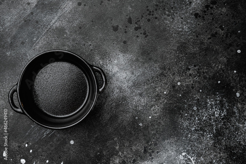 Empty serving food pot with copy space for text or food with copy space for text or food, top view flat lay , on black dark stone table background