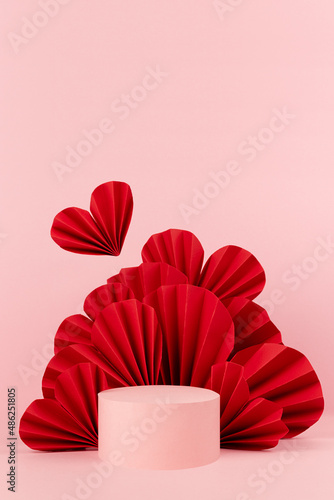 Romantic pink abstract stage mockup in chinese style with circle podium  soar red paper hearts  copy space  vertical. Passion scene template for presentation cosmetic product  advertising  display.