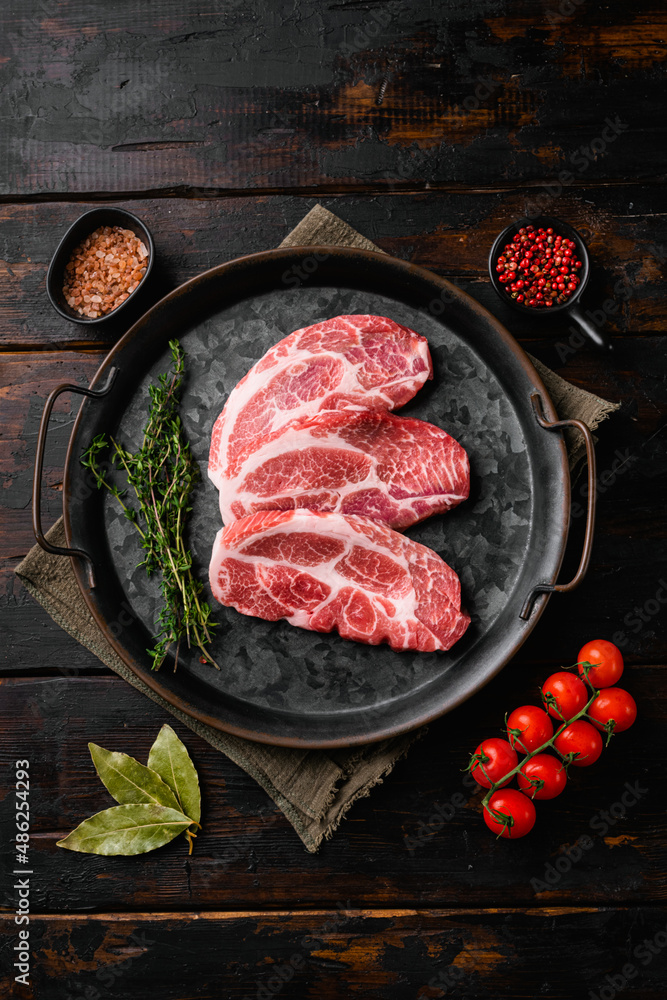 Fresh raw pork neck meat, on old dark  wooden table background, top view flat lay