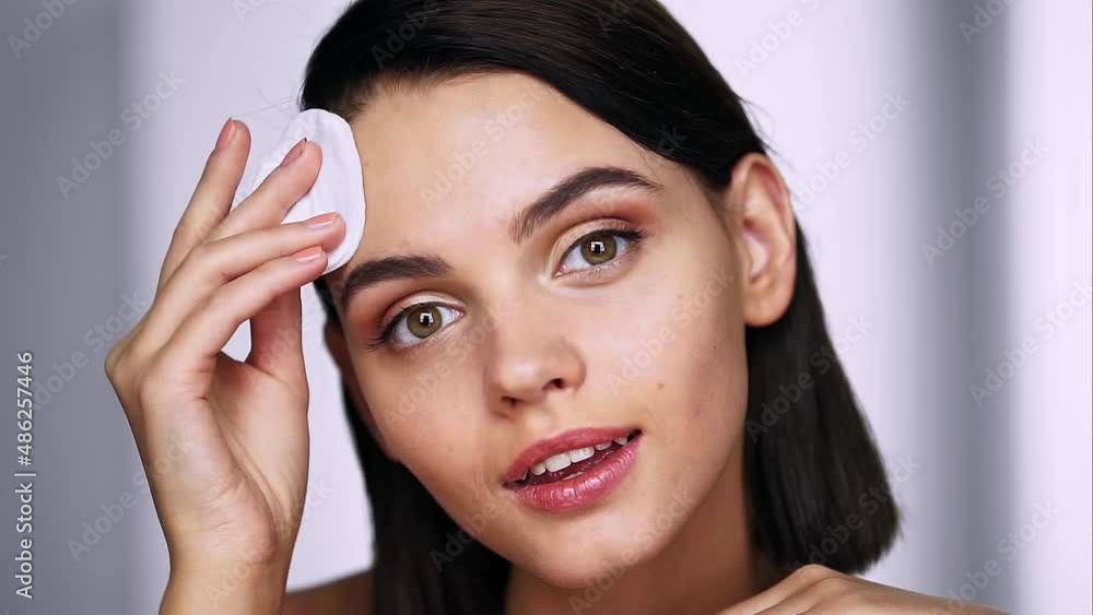 Woman removing makeup, holds cotton pads near face. Beauty and Skin care concept. Close up Woman removing makeup, holds cotton pads near face. Beauty and Skin care concept. Close up
