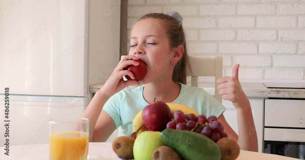 little girl in the kitchen. the child loves fruit. healthy food concept. vitamins for a child little girl in the kitchen. the child loves fruit. healthy food concept. vitamins for a child