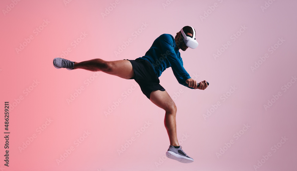 Sportsman jumping mid air with a VR headset Sportsman jumping mid air with a VR headset