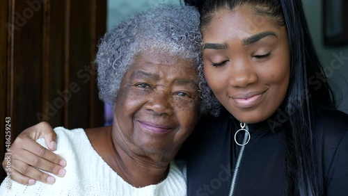 A teen granddaughter embracing grandmother a black girl embraces grandparent