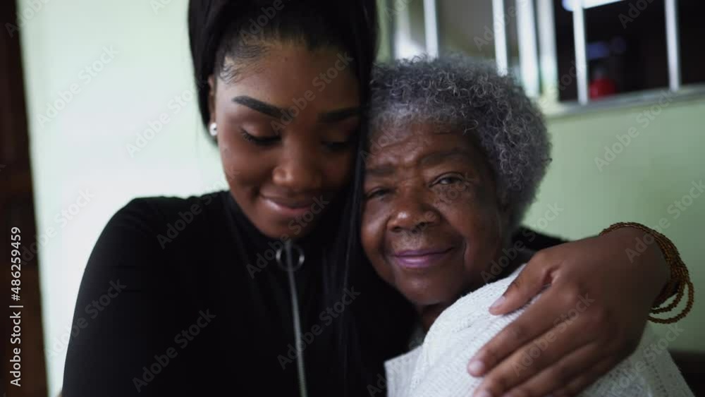 A teen granddaughter embracing grandmother a black girl embraces grandparent A teen granddaughter embracing grandmother a black girl embraces grandparent