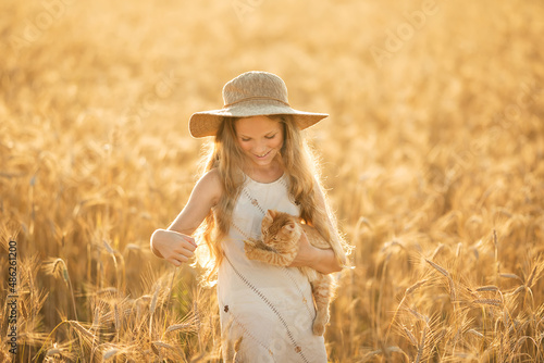 girl in a field with a cat