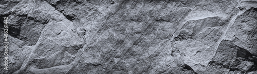 Black white rock texture. Mountain surface. Close-up. Gray granite stone background with copy space for design. Wide banner. Panoramic.