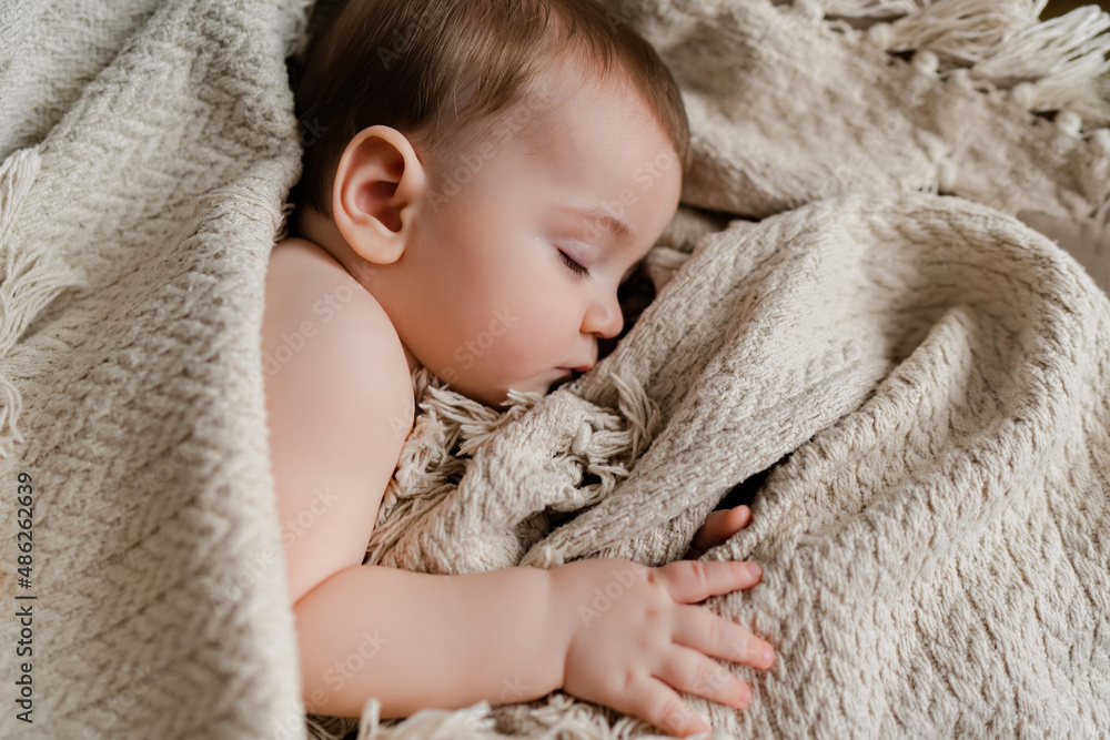 beautiful baby sleeping in a blanket. top view beautiful baby sleeping in a blanket. top view