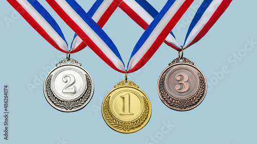 collection gold, silver, bronze medal against blue sky. award and victory concept photo