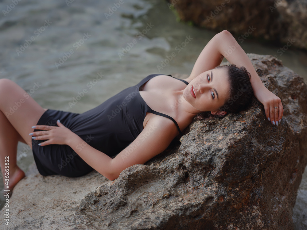 lifestyle swimwear photo-shoot of beautifaul woman on rocky beach lifestyle swimwear photo-shoot of beautifaul woman on rocky beach