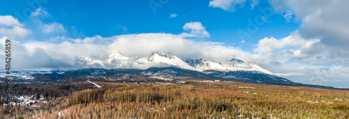 Aerial drone panoramic view of High Tatras mountain range (Vysoke Tatry in local speak), Slovakia national nature park. Winter and snow.