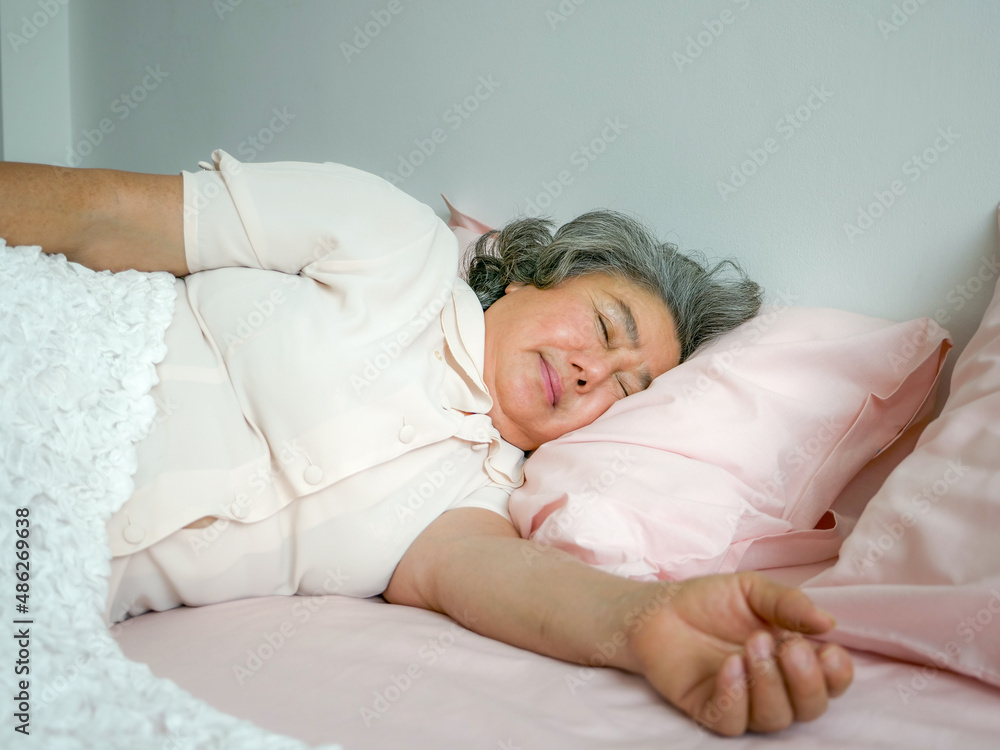 Senior woman sleep alone on bed, People lifestyle concept Senior woman sleep alone on bed, People lifestyle concept