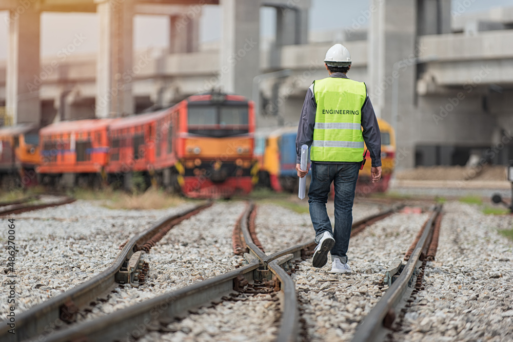 Naklejka premium engineer walking on railway inspection. construction worker on railways. Engineer work on railway.rail,engineer,Infrastructure