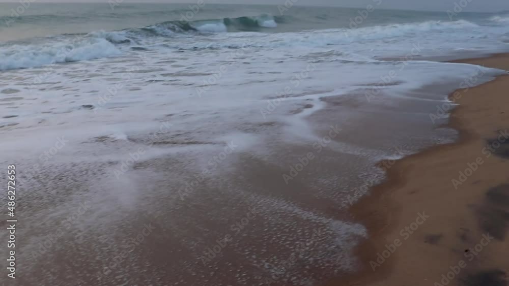 yellow sandy beach with sea wave water rushing towards it at morning yellow sandy beach with sea wave water rushing towards it at morning