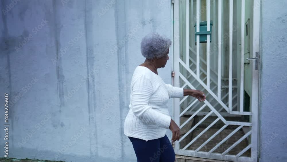 An African woman arriving home opening door entrance a black lady An African woman arriving home opening door entrance a black lady
