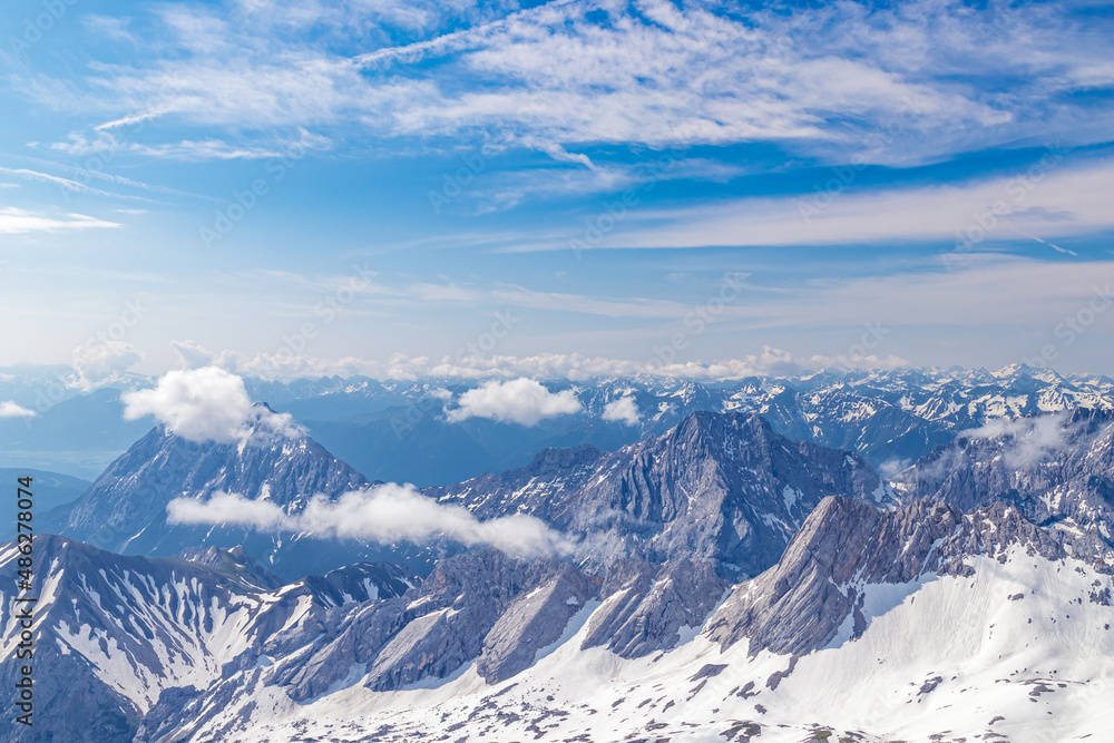 Panoramic view of the European Alps from the top of Zugspitze on a sunny summer day