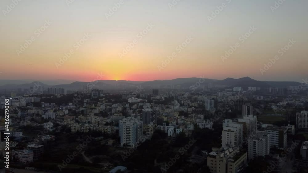 Drone Over Pune, India, Overseeing Urban Landscape During Sunset on the Backdrop of Buildings and Mountains or Hills Drone Over Pune, India, Overseeing Urban Landscape During Sunset on the Backdrop of Buildings and Mountains or Hills