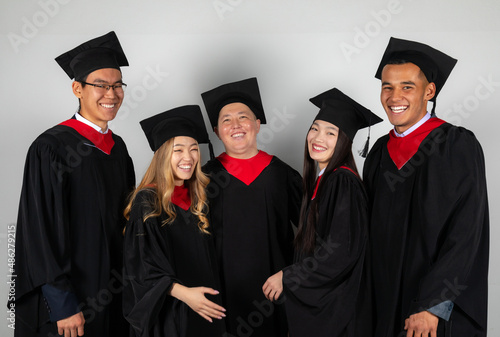 Group of graduate students friends pose together excitedly laughing