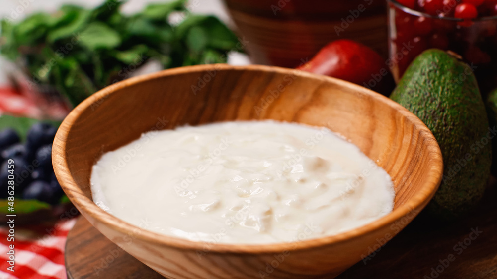 close up of fresh and sweet yogurt in wooden bowl close up of fresh and sweet yogurt in wooden bowl